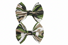 Load image into Gallery viewer, Two camouflage bows on white background without red items
